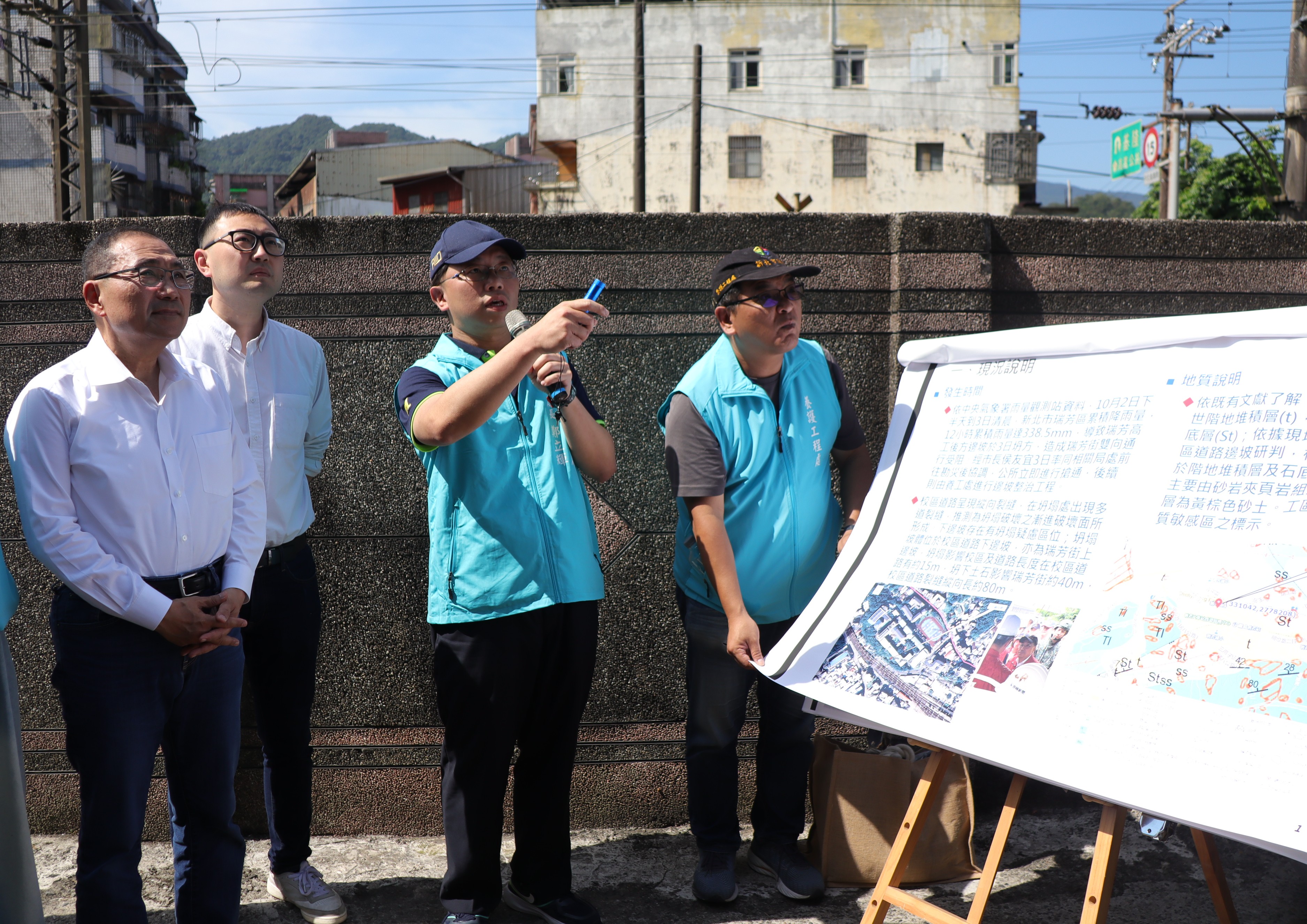 新北市長侯友宜(左一)視察瑞芳高工校區道路邊坡坍方完工現況，養工處長鄭立輝(左三)在場簡報說明。